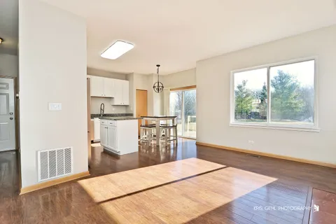 a kitchen with stainless steel appliances kitchen island granite countertop a refrigerator and microwave