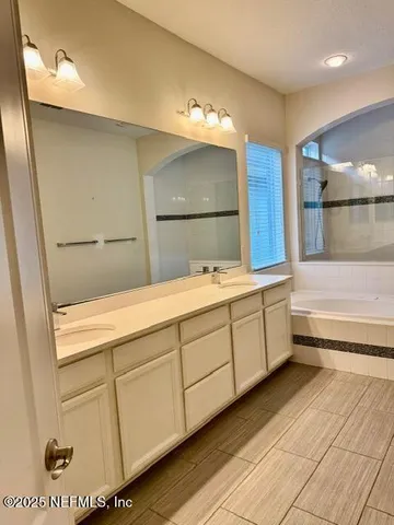 a bathroom with a bathtub and a shower