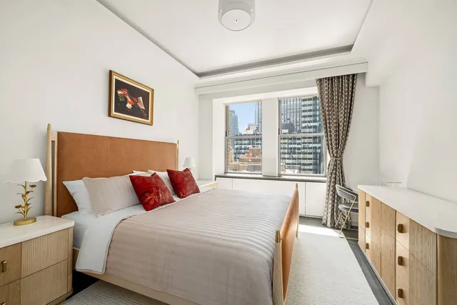 a close view of a sink a mirror and a lamp in a bathroom