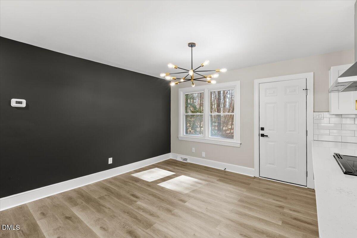 2501 Old Mill Road Rocky Mount, NC 27803 - Photo 11 of 41 wooden floor in an empty room with a window