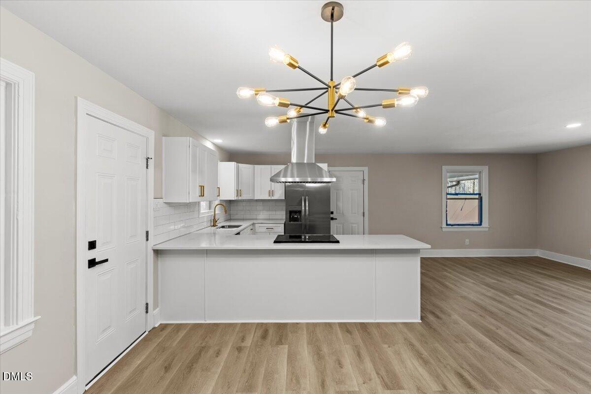 2501 Old Mill Road Rocky Mount, NC 27803 - Photo 13 of 41 a view of a kitchen with a sink dishwasher a refrigerator and wooden floor