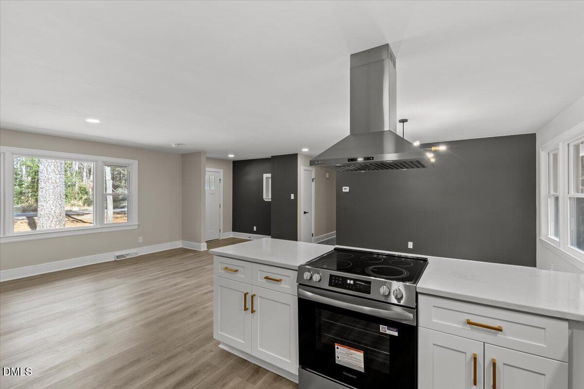 2501 Old Mill Road Rocky Mount, NC 27803 - Photo 15 of 41 a kitchen with a stove and white cabinets