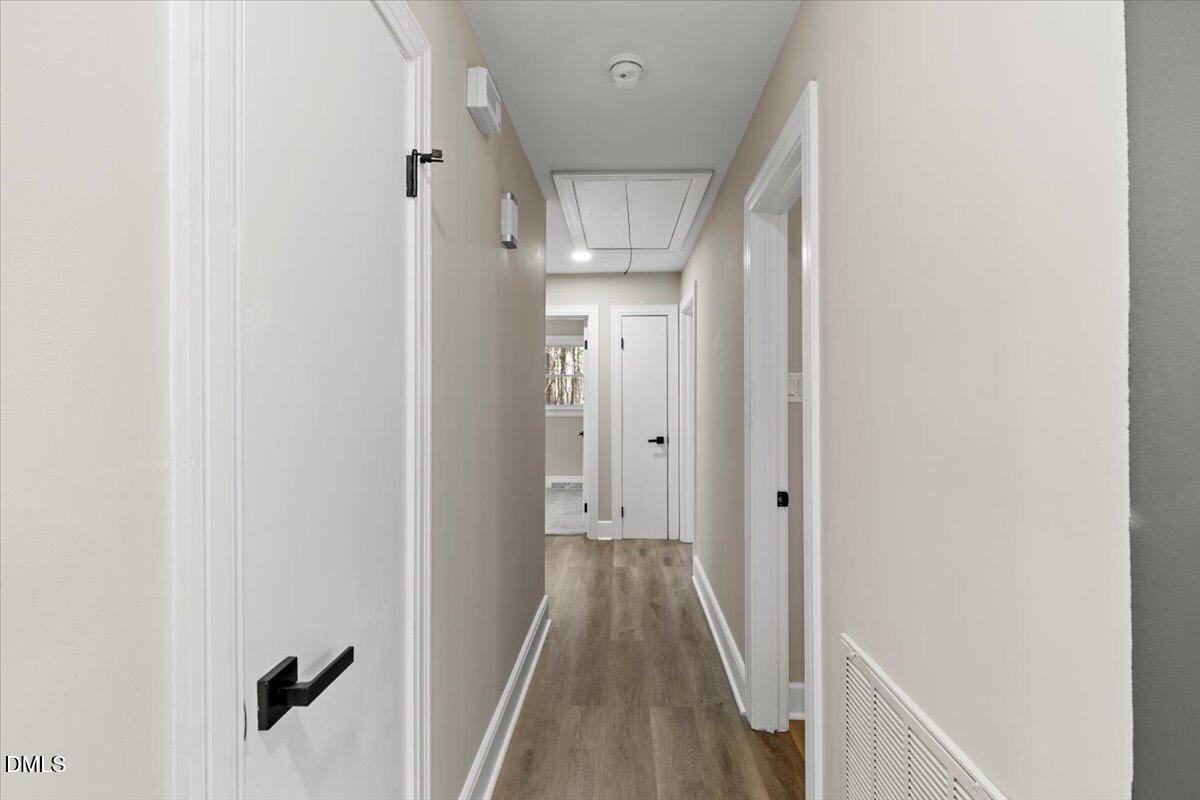 2501 Old Mill Road Rocky Mount, NC 27803 - Photo 17 of 41 a view of a hallway with wooden floor and staircase