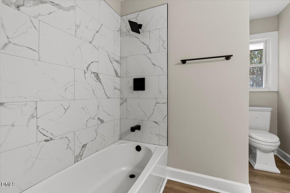 2501 Old Mill Road Rocky Mount, NC 27803 - Photo 18 of 41 a bathroom with a bathtub and a toilet