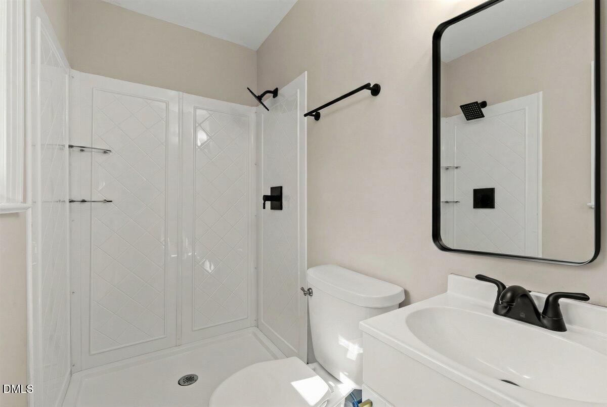 2501 Old Mill Road Rocky Mount, NC 27803 - Photo 27 of 41 a bathroom with a sink toilet and shower