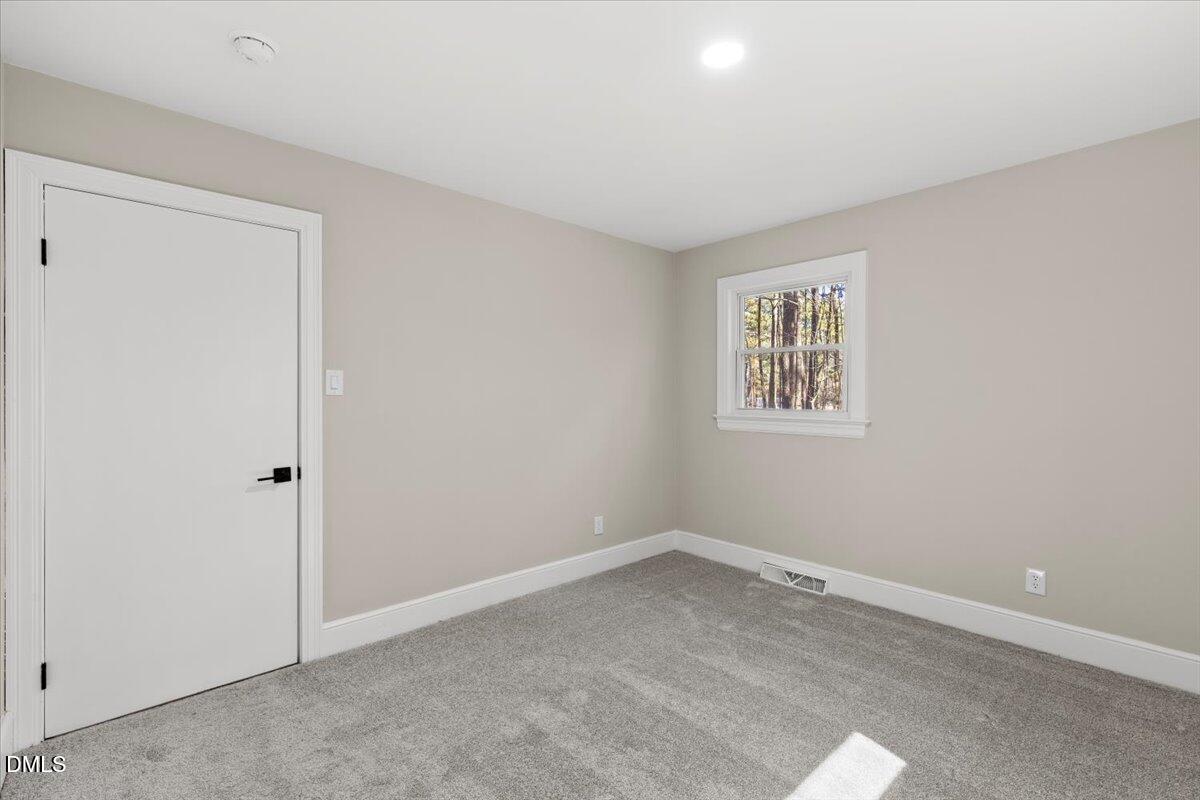 2501 Old Mill Road Rocky Mount, NC 27803 - Photo 28 of 41 an empty room with a hallway