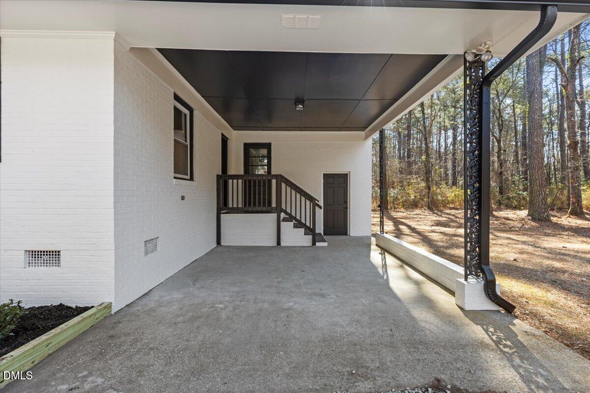 2501 Old Mill Road Rocky Mount, NC 27803 - Photo 36 of 41 a view of an empty room with a floor to ceiling window and stairs