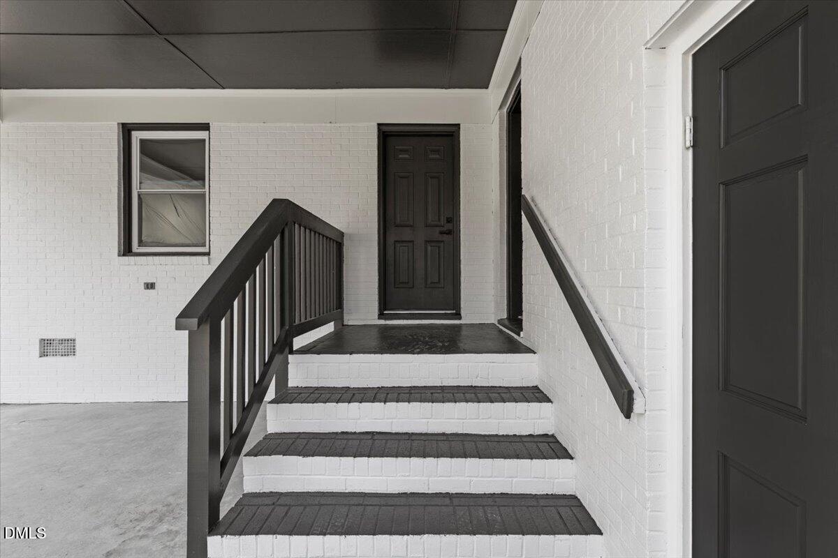 2501 Old Mill Road Rocky Mount, NC 27803 - Photo 38 of 41 a view of staircase with wooden floor and white walls