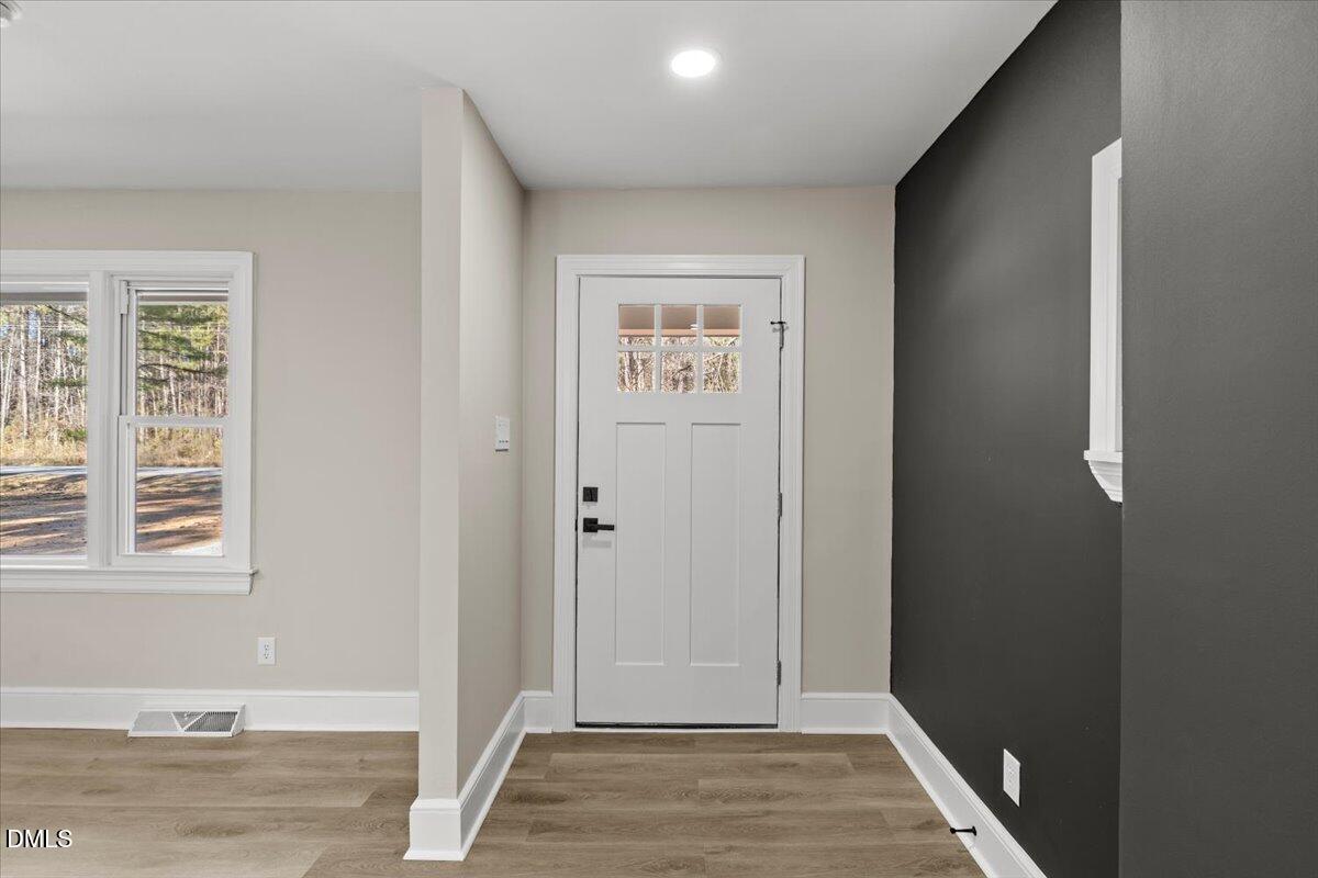 2501 Old Mill Road Rocky Mount, NC 27803 - Photo 6 of 41 a view of hallway with window and wooden floor