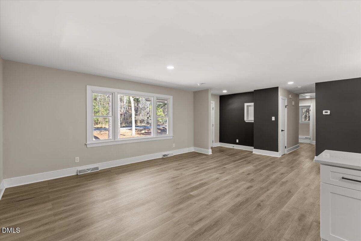 2501 Old Mill Road Rocky Mount, NC 27803 - Photo 8 of 41 a view of an empty room with wooden floor and a window