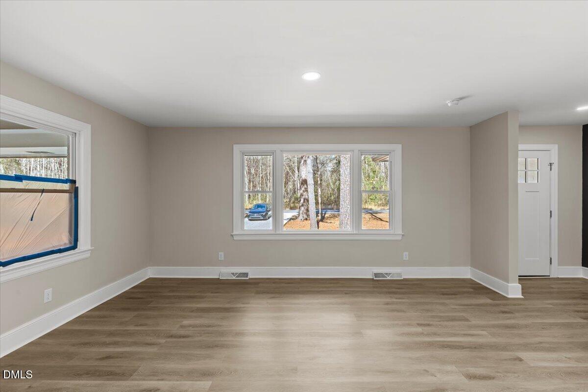 2501 Old Mill Road Rocky Mount, NC 27803 - Photo 10 of 41 an empty room with wooden floor and windows