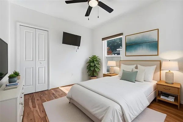 a bedroom with a bed and a potted plant