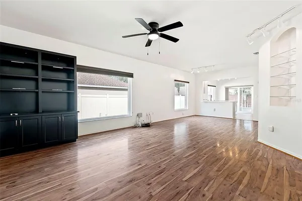 a view of room with wooden floor and ceiling fan