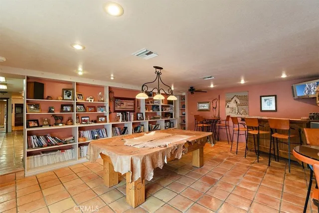a bedroom with a bed a book shelf and a window