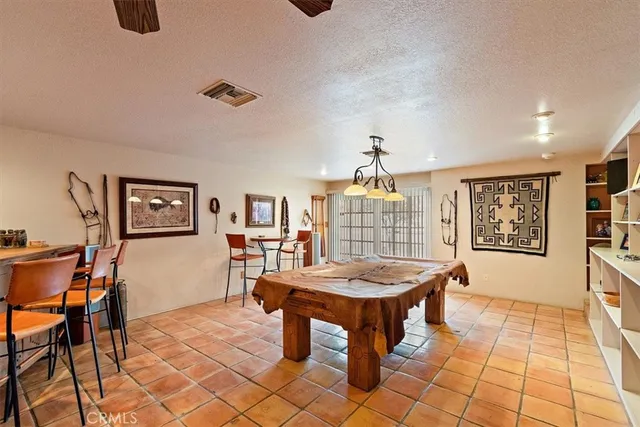 a view of a patio with table and chairs with wooden fence and floor
