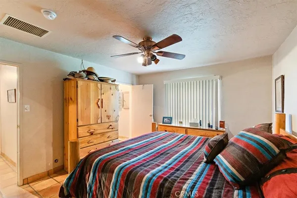 a view of a swimming pool with a patio and a yard