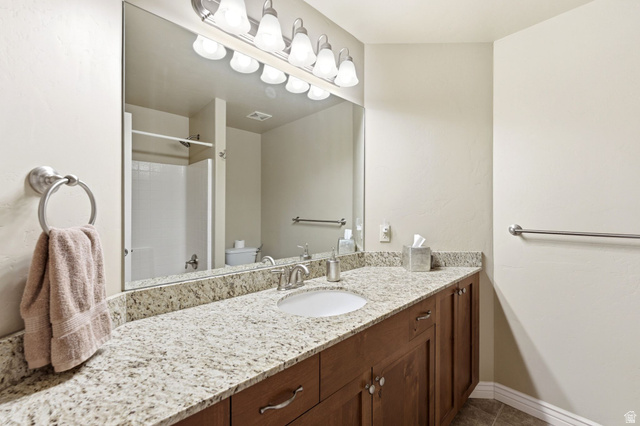 7235 Viansa Court Midvale, UT 84047 - Photo 26 of 43 Bathroom with vanity and a shower