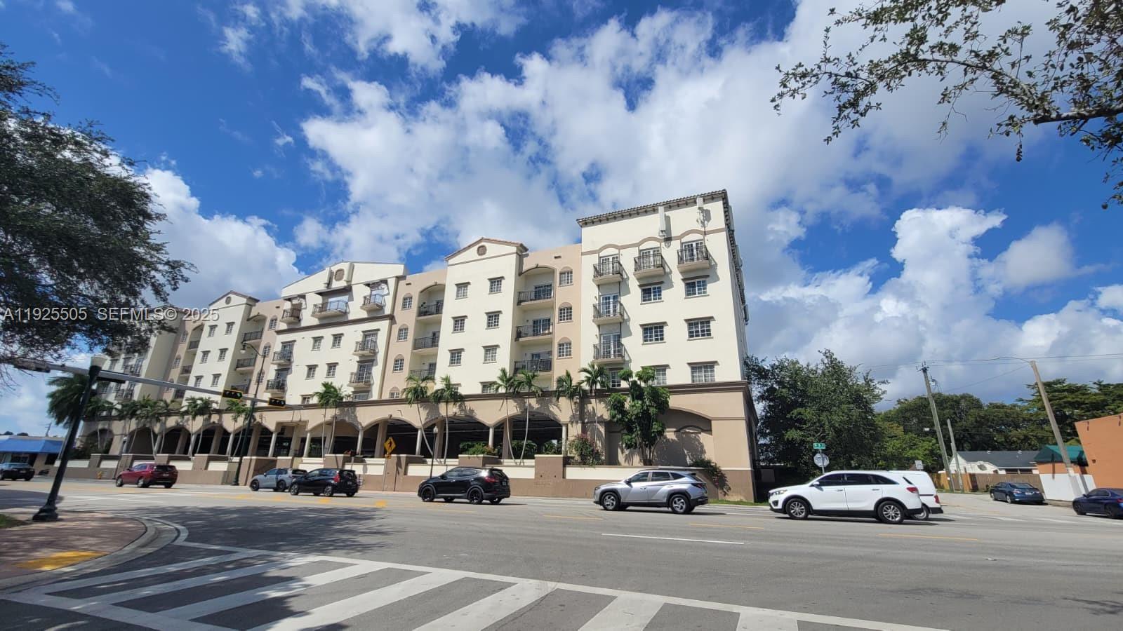 5271 Southwest 8th Street, Unit 411 Miami, FL 33134 - Photo 2 of 14 a view of a parked cars in front of a building