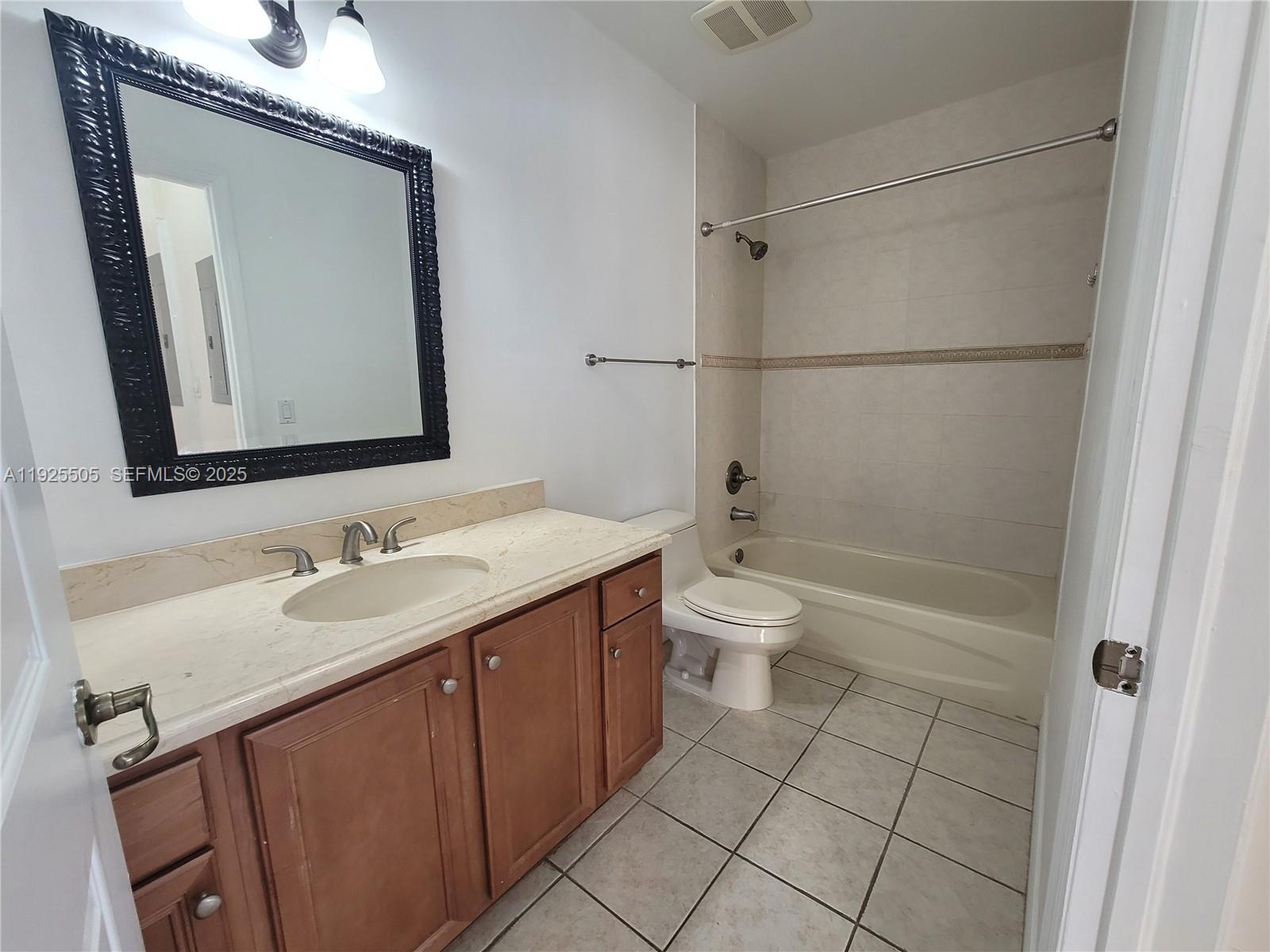 5271 Southwest 8th Street, Unit 411 Miami, FL 33134 - Photo 7 of 14 a bathroom with a sink a toilet and shower