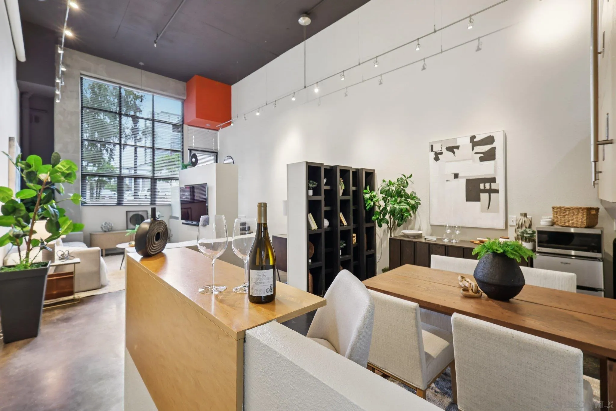 777 Sixth Avenue, Unit 135 San Diego, CA 92101 - Photo 11 of 38 a living room with furniture potted plant and kitchen appliances