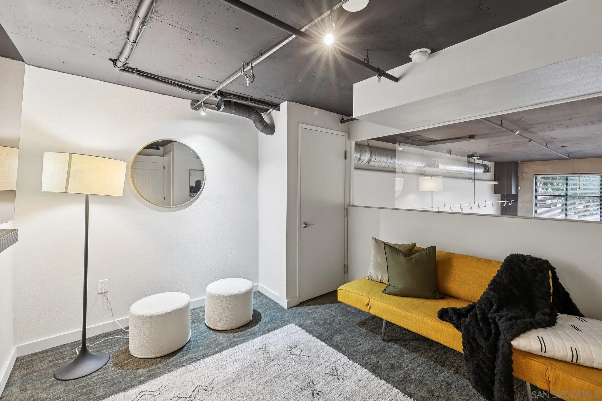 777 Sixth Avenue, Unit 135 San Diego, CA 92101 - Photo 19 of 38 a living room with furniture and a mirror