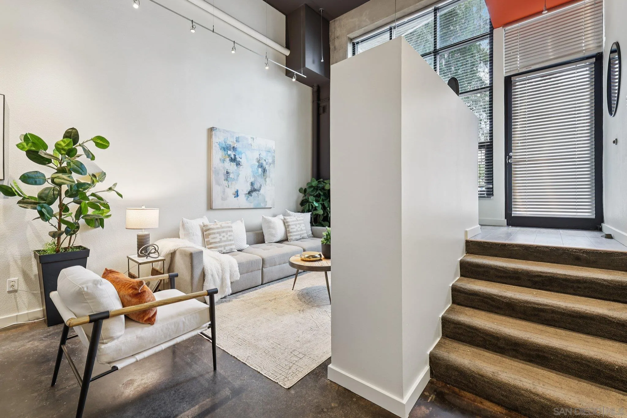 777 Sixth Avenue, Unit 135 San Diego, CA 92101 - Photo 4 of 38 a living room with furniture and a potted plant