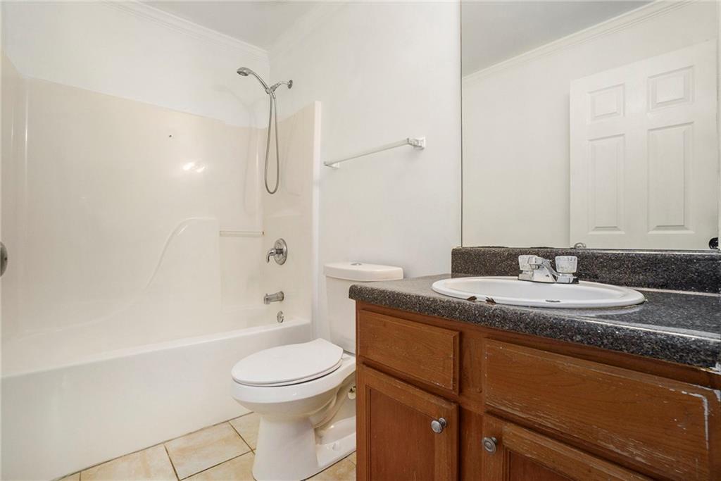 719 Magnolia Street Northwest Atlanta, GA 30314 - Photo 13 of 13 a bathroom with a granite countertop sink a toilet and shower