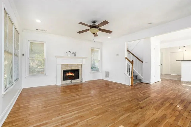 a view of a livingroom with a fireplace and a chandelier fan