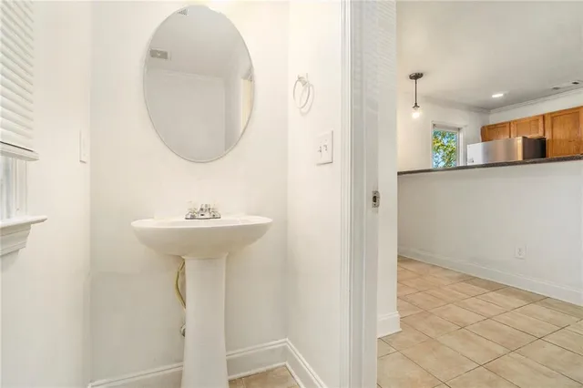 a view of a hallway with wooden floor and a sink