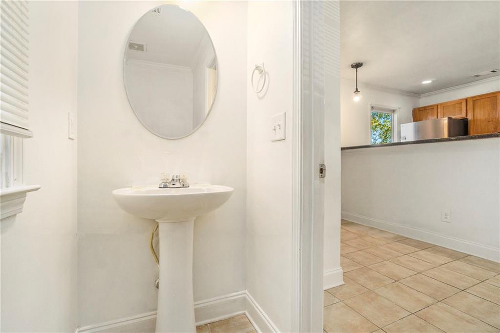 719 Magnolia Street Northwest Atlanta, GA 30314 - Photo 6 of 13 a view of a hallway with wooden floor and a sink