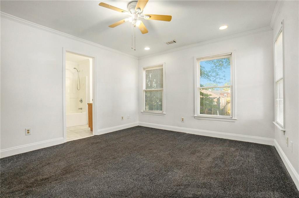 719 Magnolia Street Northwest Atlanta, GA 30314 - Photo 8 of 13 an empty room with windows and fan