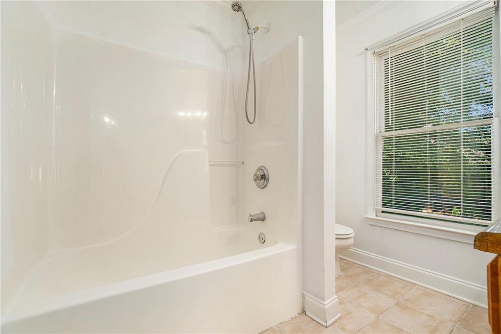 719 Magnolia Street Northwest Atlanta, GA 30314 - Photo 10 of 13 a bathroom with a bathtub and a shower