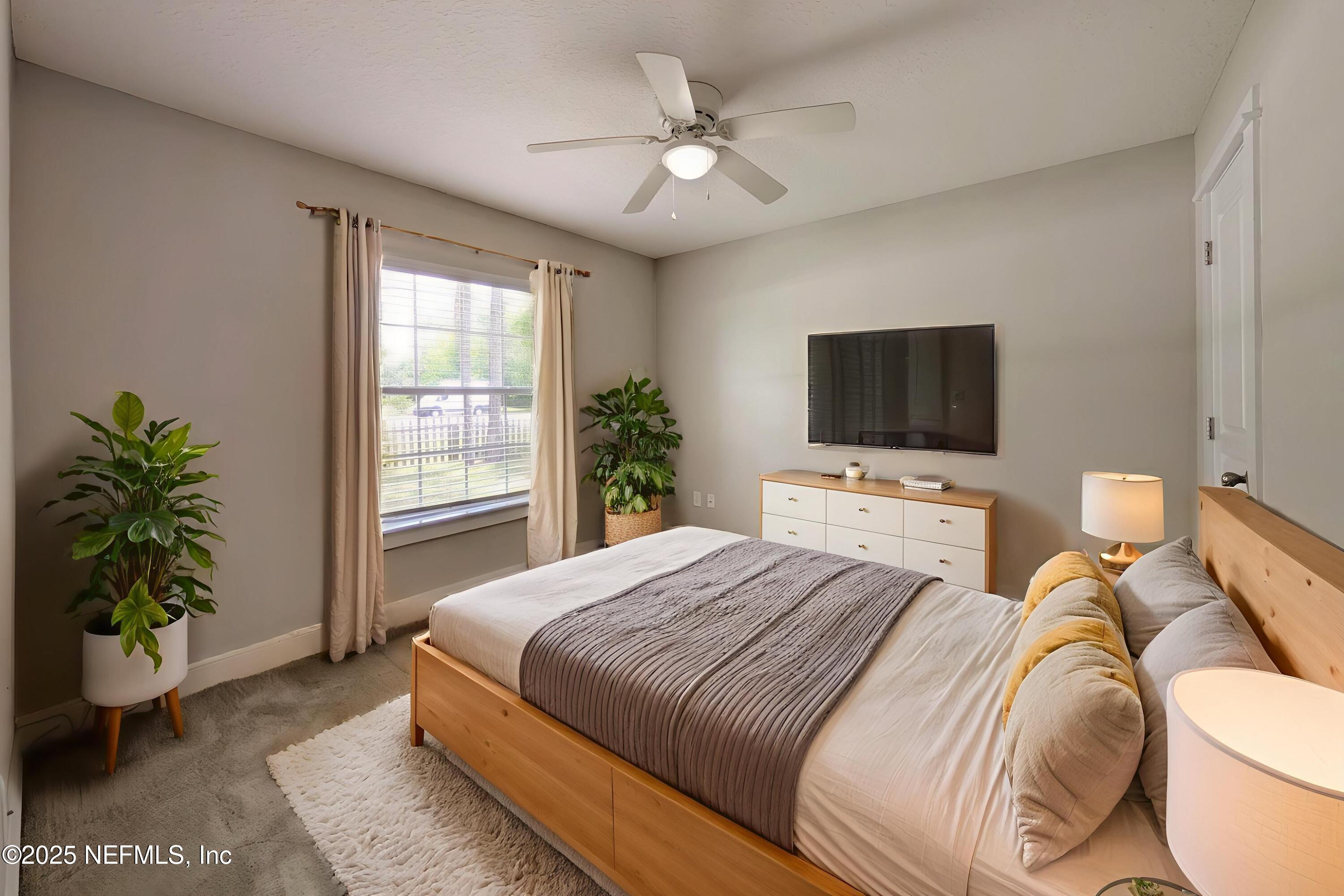 12950 Old St Augustine Road Jacksonville, FL 32258 - Photo 12 of 22 a bedroom with a bed and a television