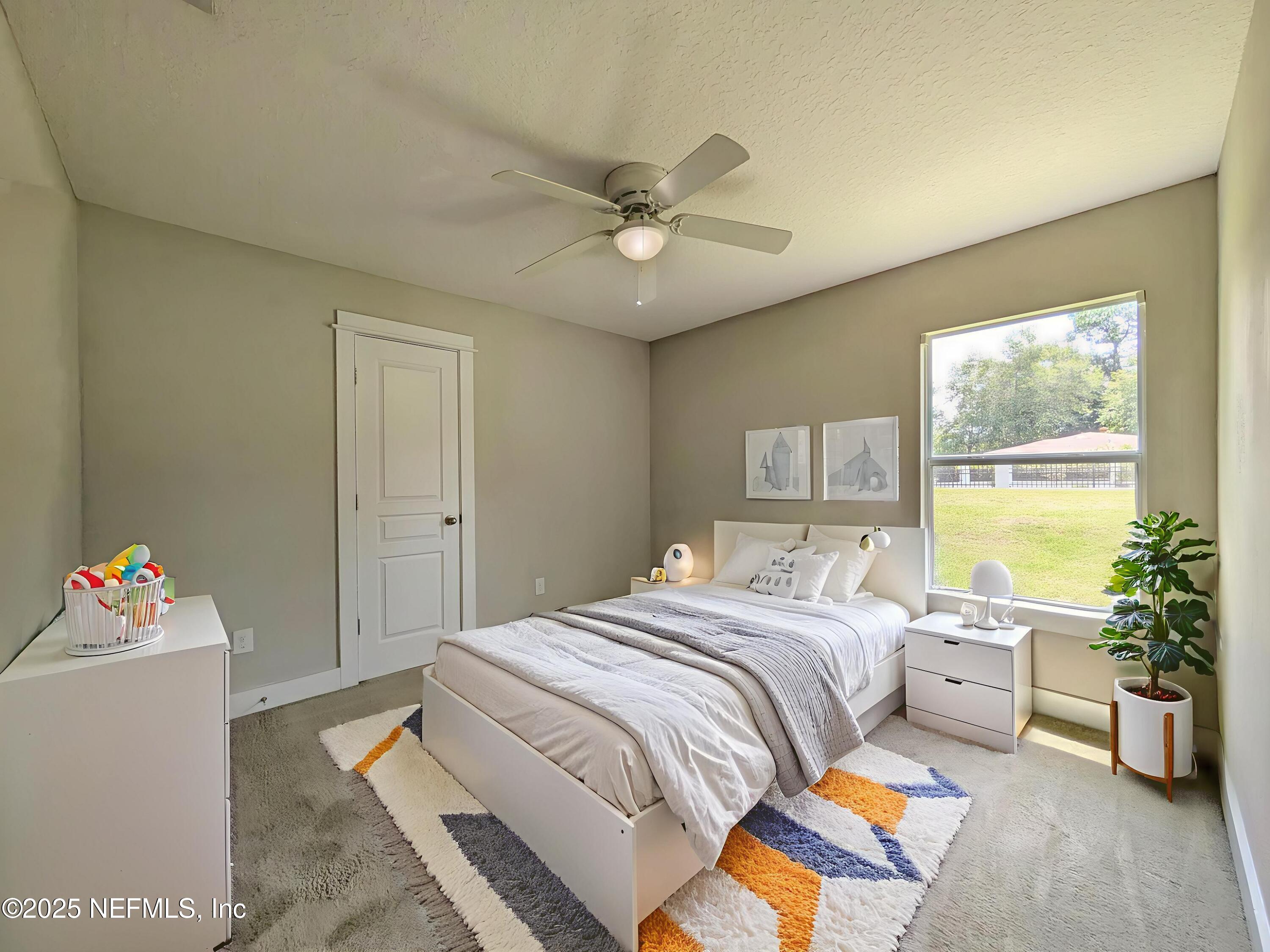 12950 Old St Augustine Road Jacksonville, FL 32258 - Photo 14 of 22 a bed room with a bed and a chandelier