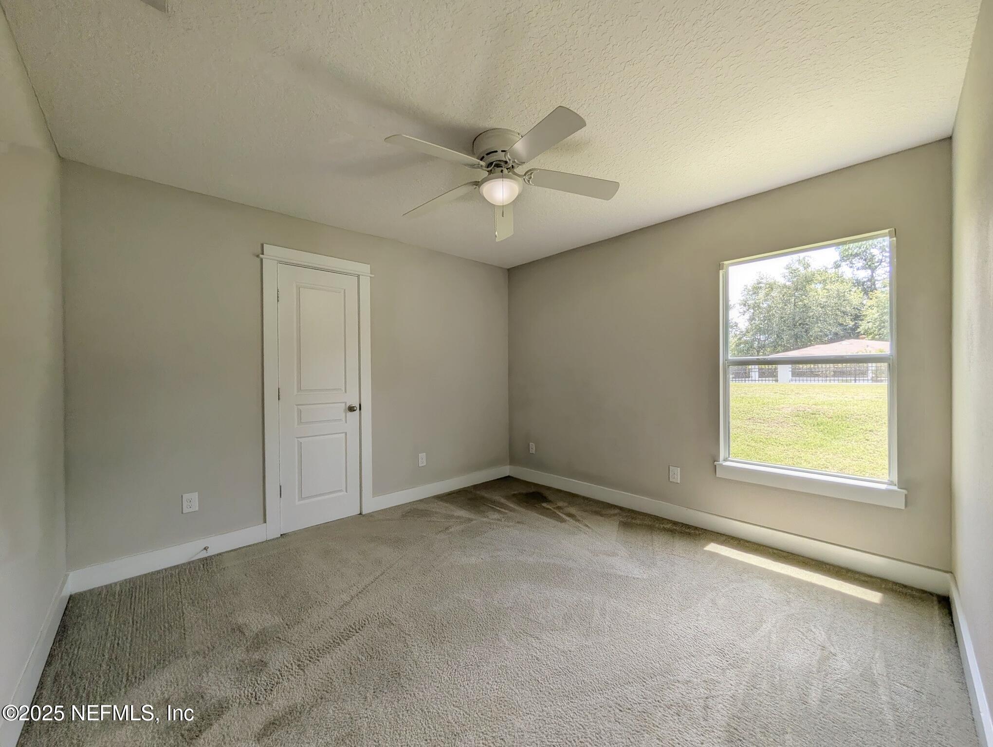 12950 Old St Augustine Road Jacksonville, FL 32258 - Photo 15 of 22 an empty room with a window and a ceiling fan