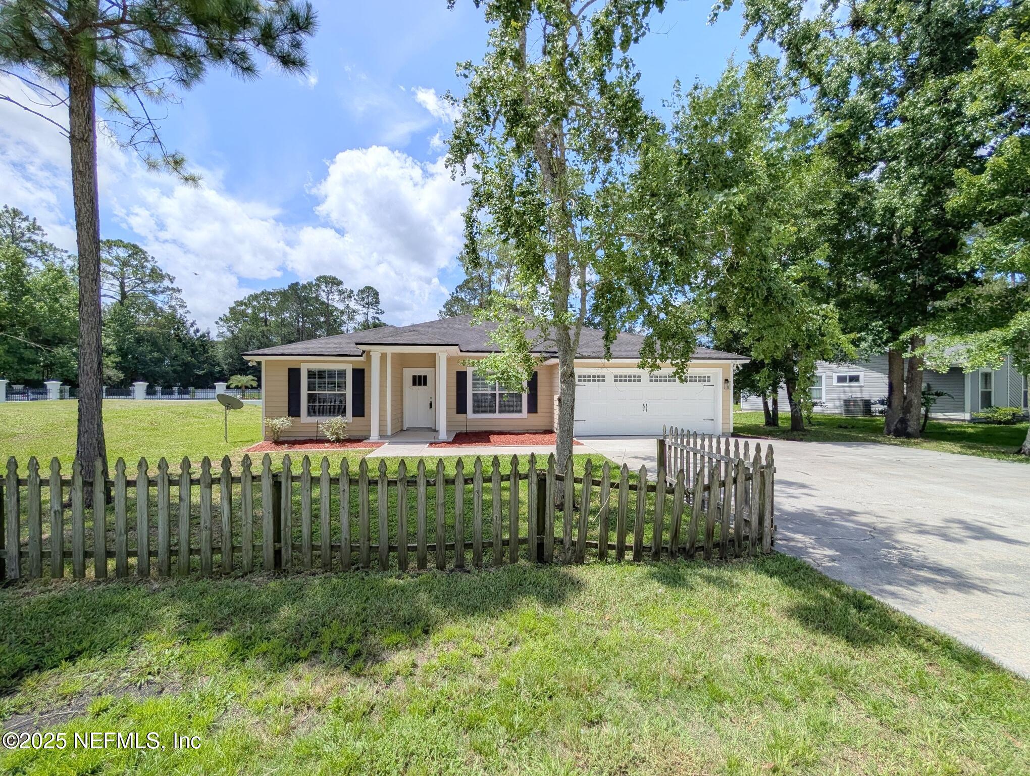 12950 Old St Augustine Road Jacksonville, FL 32258 - Photo 2 of 22 a front view of a house with garden