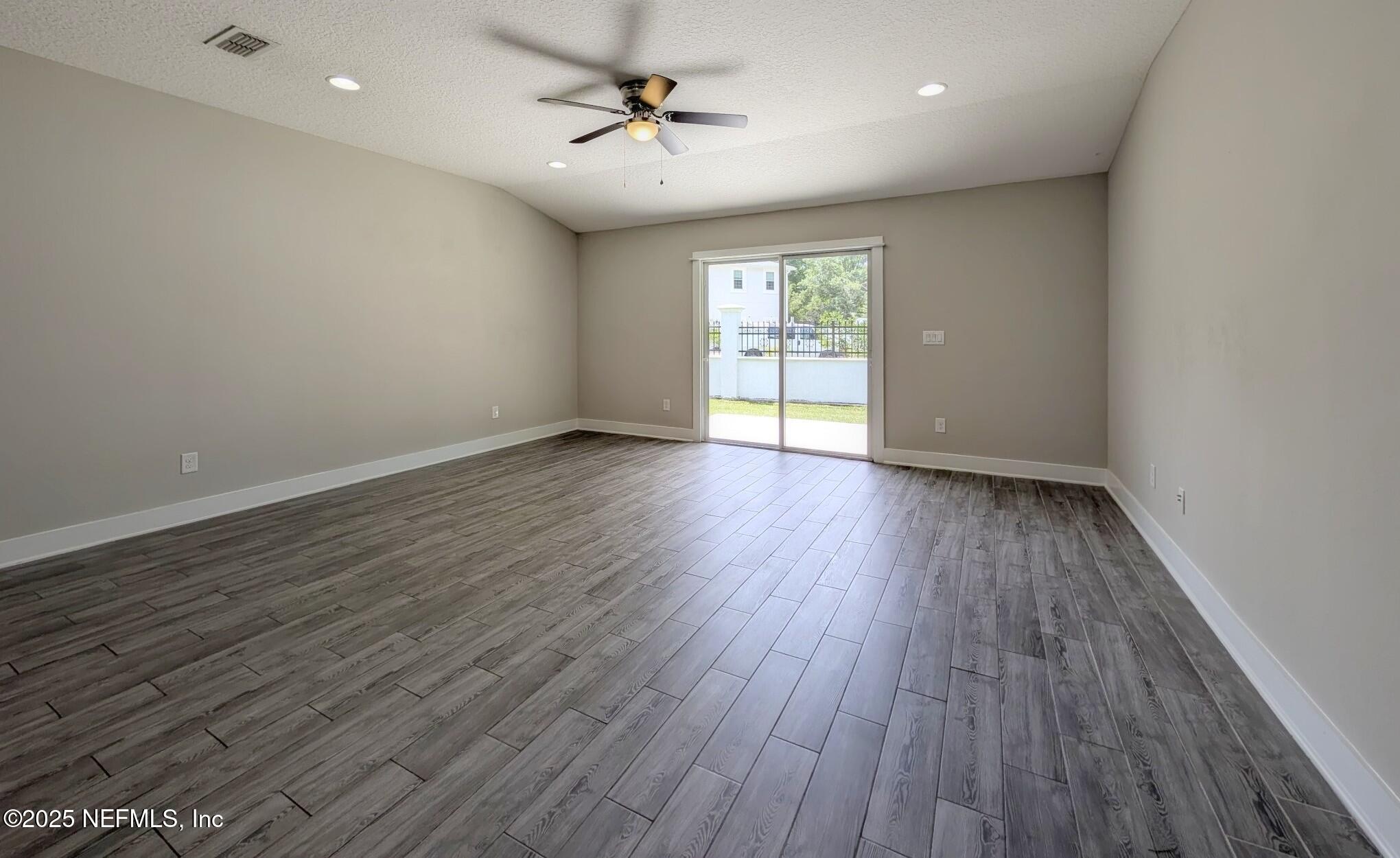 12950 Old St Augustine Road Jacksonville, FL 32258 - Photo 4 of 22 wooden floor in an empty room with a window