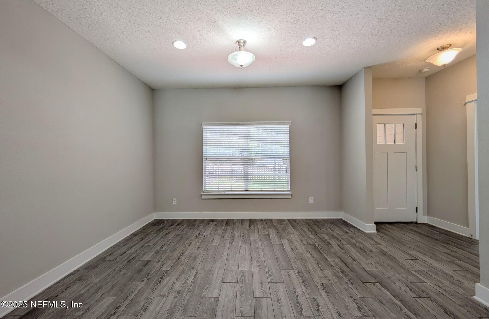12950 Old St Augustine Road Jacksonville, FL 32258 - Photo 6 of 22 wooden floor in an empty room with a window