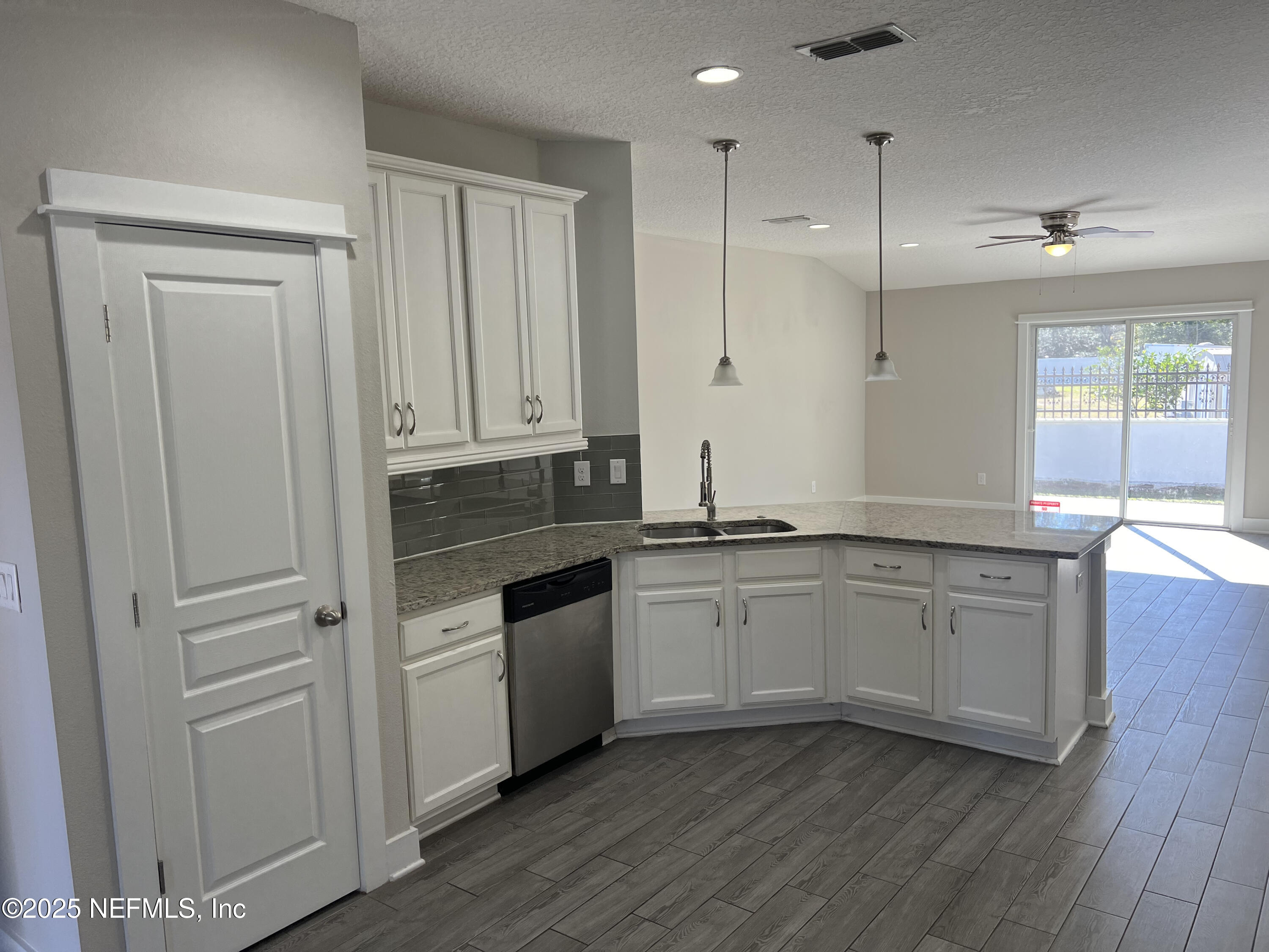 12950 Old St Augustine Road Jacksonville, FL 32258 - Photo 7 of 22 a kitchen with granite countertop white cabinets and white appliances