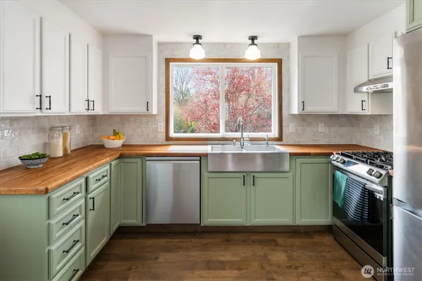 a kitchen with a sink stove and cabinets