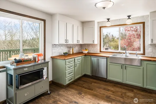 a kitchen with a stove a sink and a window