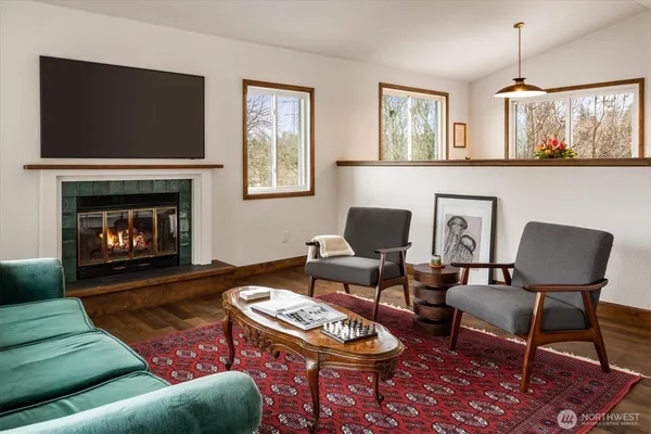 a living room with furniture a rug and a fireplace