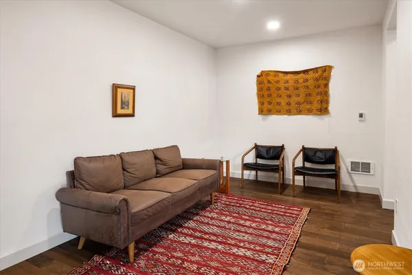 a living room with furniture and a wooden floor