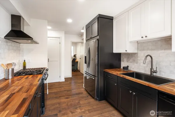 a kitchen with stainless steel appliances a sink stove and refrigerator