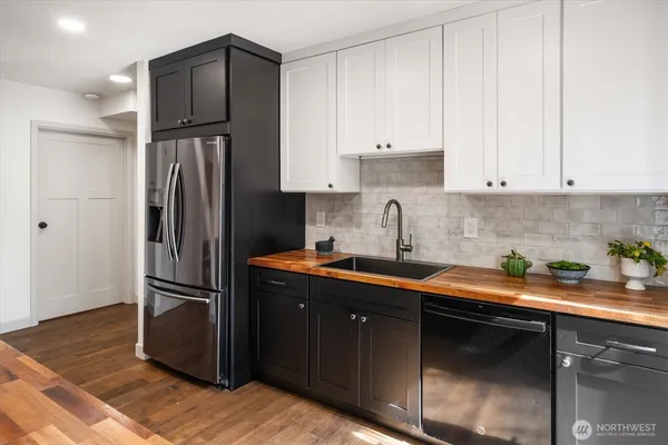 a kitchen with stainless steel appliances granite countertop a refrigerator sink and cabinets