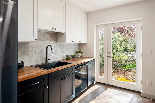 a kitchen with stainless steel appliances granite countertop a sink stove and cabinets