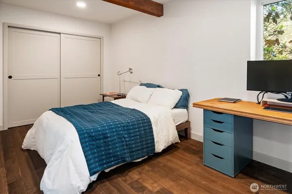 a bedroom with a bed and a flat screen tv