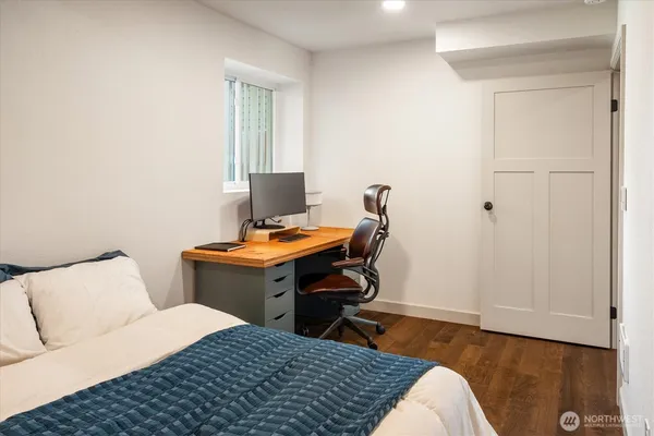 a bedroom with a bed and a desk