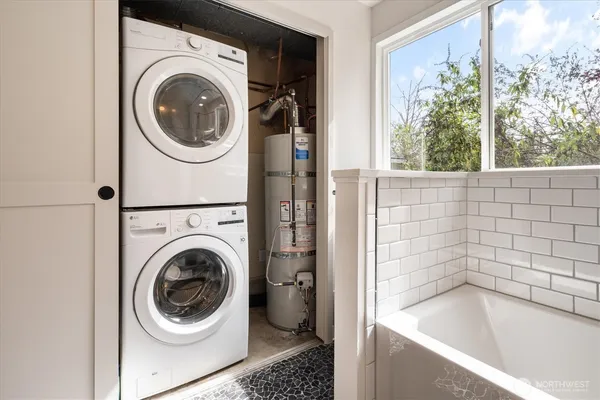 a bathroom with a bathtub and a window