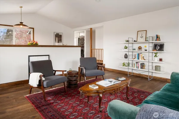 a living room with furniture rug and wooden floor